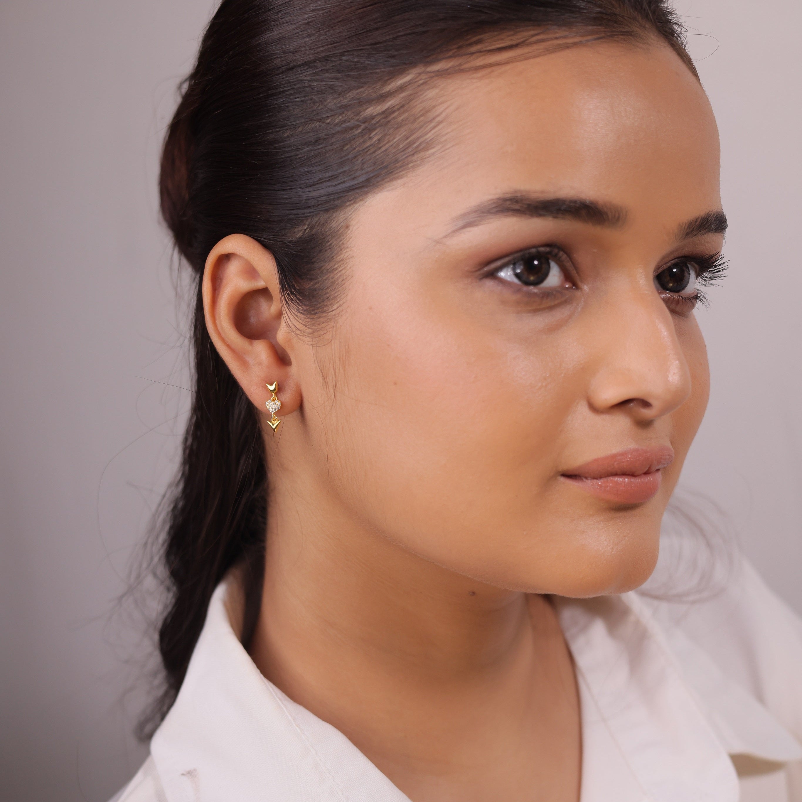 92.5 Sterling Silver CZ Stone Light Weight Gold Plated Dangled Earrings With A Heart And Arrow Design For Women By Kesardeep